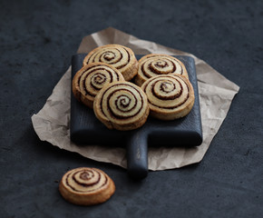 Cookies twisted with cinnamon and milk festive on a dark background, Christmas and New Year