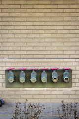 Fire hose manifold in a commercial building with Cream City brick.