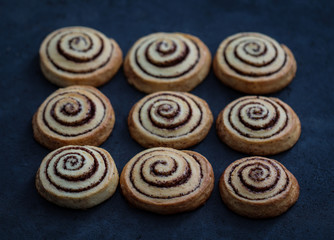 Cookies twisted with cinnamon and milk festive on a dark background, Christmas and New Year