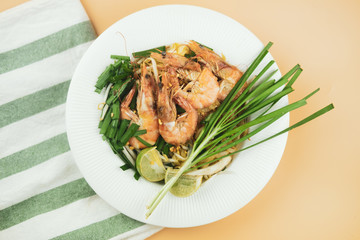 Plate of Pad Thai or Thai style fried noodle topped with prawns