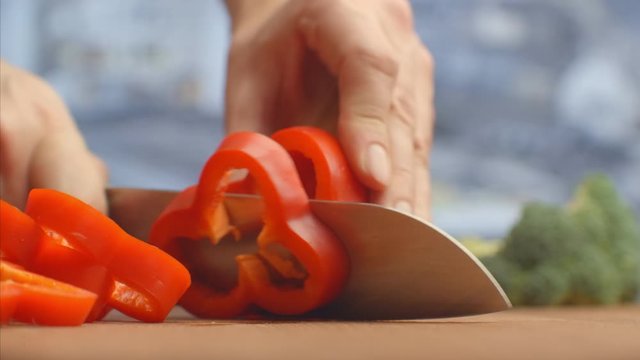 Red pepper cut on a wooden board close-up. shred