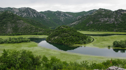 panoramic view of the island on Skadar Lake and the forested mountains around