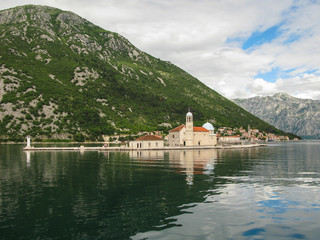 panoramic view from the ship to Perast, Gospa od Skrpjela, Kotor bay and the surrounding mountains,...