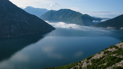 Obraz premium islands in fog in a Kotor bay near the city of Perast at sunrise, Montenegro