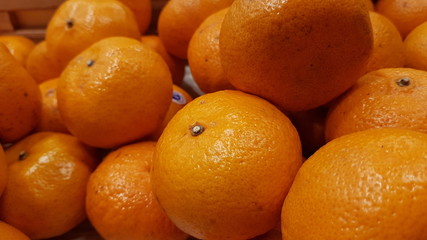 Oranges on display shelf at a market