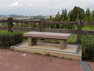 Fototapeta na wymiar Stone bench in a park