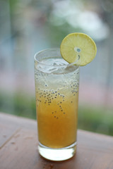 Fresh Juice Orange with basil seeds in blurred background. Ice Orange