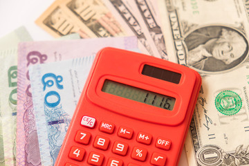 Thailand Baht, Chinese Yuan, US Dollar banknotes and Thailand Baht coin. calculation amount of...