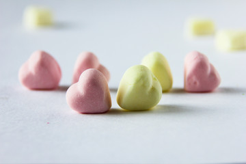 marshmallow in the sight of hearts lies on the surface of the white table
