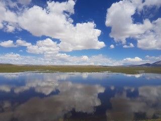 blue sky reflected on calm water on a sunny day