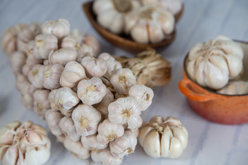 Garlic is placed on the white table in the kitchen, preparing for cooking,