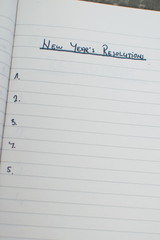 list of new year's resolutions in a notebook