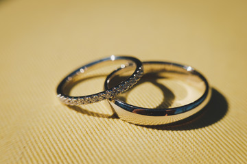 wedding rings on yellow background