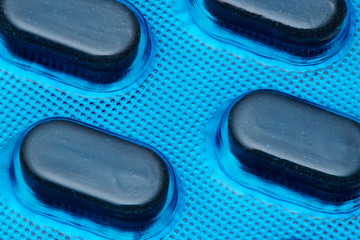 Blue tablets in blister pack arranged with beautiful pattern. Global healthcare concept. Antibiotics drug resistance. Antimicrobial capsule pills. Pharmaceutical industry. Pharmacy.