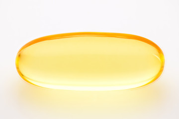 Omega 3 fish oil, one gel capsule macro photo over white background, food supplement for health...