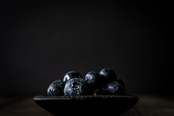 blueberries with dark background. Dark food photo. Moody food photo