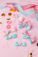Set of baby accessories for hair on a pink pastel background. Concept of baby party, birthday, beauty hair saloon for kids, kawaii hairpins, Place for text