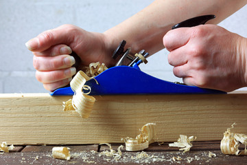 Skilled Craftsman Using A Carpenters Wood Plane.