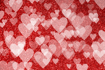 Shiny red background with glitter effect and heart shaped bokeh