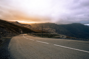 Scenic road in the Alps mountains at sunset