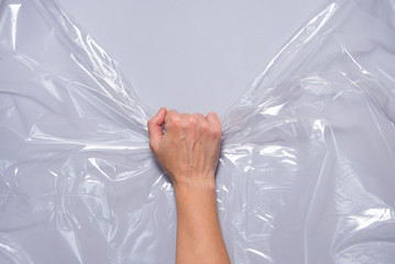 Woman hands pull polyethylene film