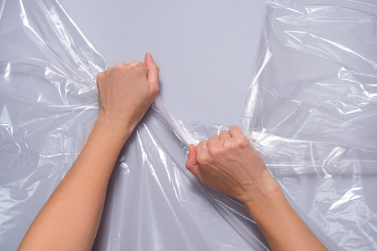 Woman hands pull polyethylene film