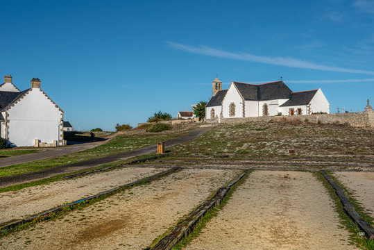 Bouling game place in the village of Hoedic Island in French Brittany, France., the church Notre Dame la Blanche is at background. Brittany