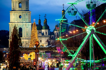 Fototapeta na wymiar Street Decorated at bright festive illuminations and Christmas Tree on Sofia Square in Kyiv, Ukraine. December 2019