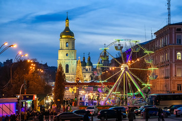 Fototapeta na wymiar Street Decorated at bright festive illuminations and Christmas Tree on Sofia Square in Kyiv, Ukraine. December 2019