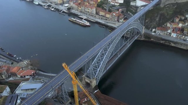 Aerial view tilt up, Porto Old Town and Dom Luis Bridge over the Douro river in Porto, Portugal, 4k drone footage.