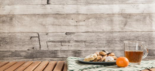 Festive time with home made cookies on the wodden table with wooden background