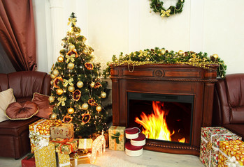 Christmas fir-tree, christmas decorations and gifts near fireplace in festive interior. New year.