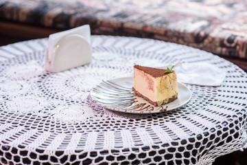 Philadelphia cheesecake on a table in a cozy chocolate bar. Tasty food.