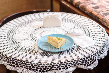 Napoleon cake on the table in a cozy chocolate bar. Tasty and not healthy food.