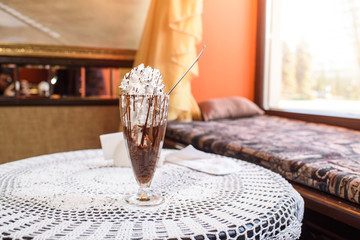 Chocolate dessert on a table in a cozy chocolate bar. Light and cool food.