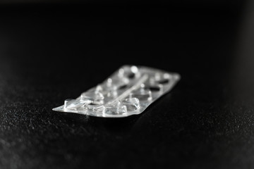 Empty blister from pills lies on the table