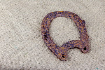 Close up of an old, rusted horseshoe. It is a soil find and was in a field for many years. Concept: archeology and soil finds