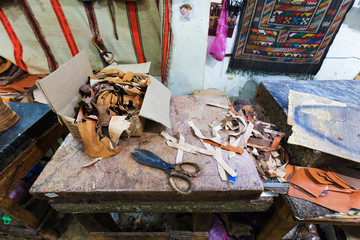 The traditional handmade leather handbag and slippers and other product is displayed in the tannery and showroom in the souk of Fes. Morocco
