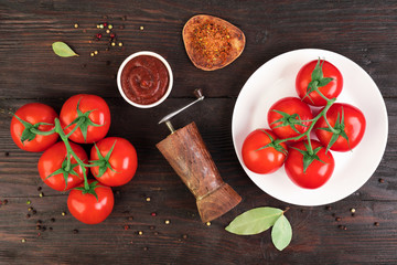 Fresh bunch tomatoes on rustic wooden table