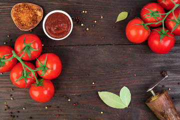 Fresh bunch tomatoes on rustic wooden table