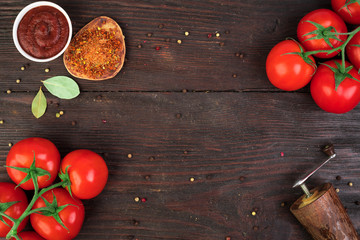 Fresh bunch tomatoes on rustic wooden table