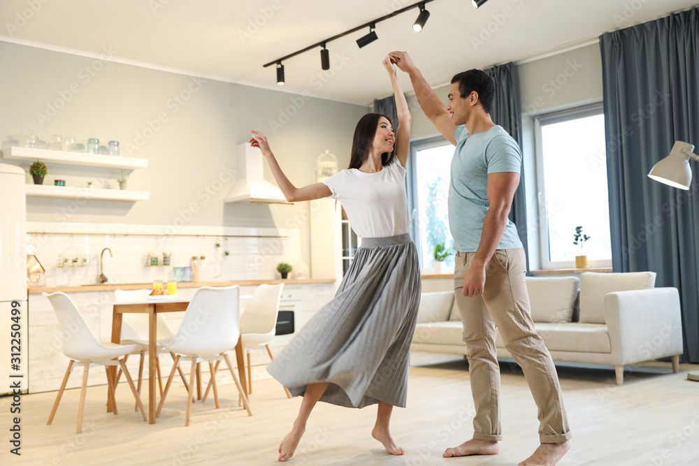 Canvas Prints Lovely young interracial couple dancing at home