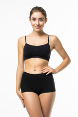 Obraz premium Dama fitness z pięknym ciałem w czarnej bieliźnie na białym tle