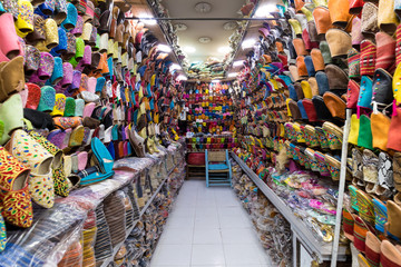The traditional handmade leather handbag and slippers and other product is displayed in the tannery...