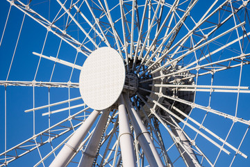 Big ferris wheel moves. Bright photo of the amusement park.  Ferris wheel in the park. 