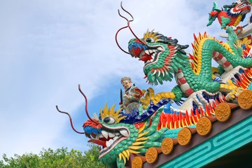 Fototapeta premium Dragons, ornaments and other religious symbols on a Chinese shrine in Phuket, Thailand. 