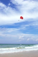 Parasailing on the beach of Phuket, Thailand, on a sunny day.
