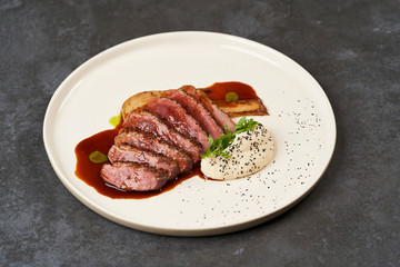 Baked Chicken Fillet with Celery Puree and sauce on white plate