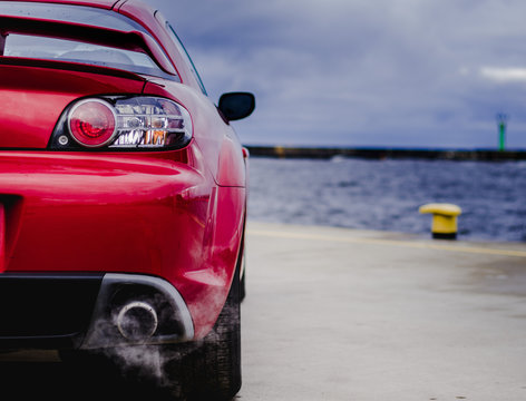 Red  sports car in harbor 
