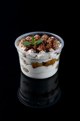 Tiramisu with fresh mint on a background